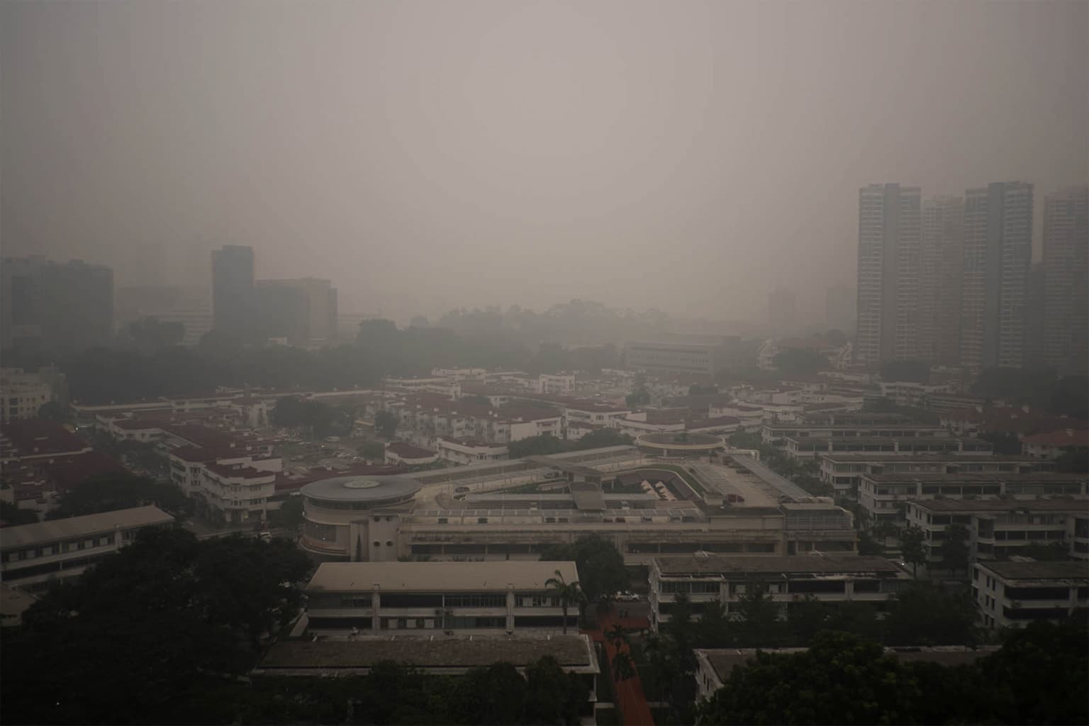 A haze hanging over Singapore in Sept., 2015, from buring forests in Sumatra and Borneo. Image by Charles EYES PiX via Flickr (CC BY-SA 2.0).
