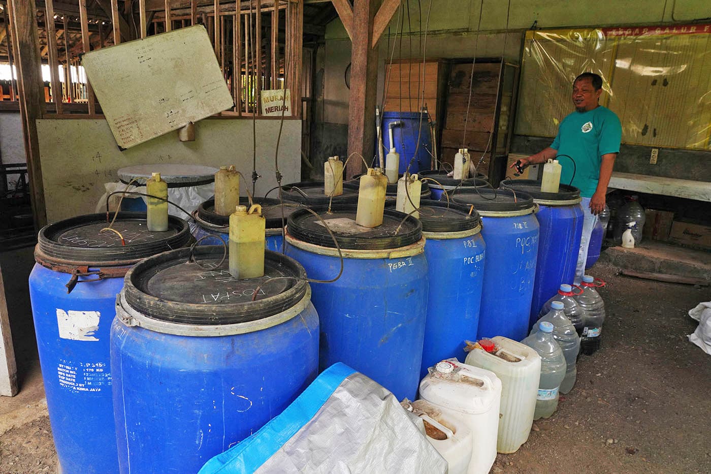 Ganjar shows drums used in the fermentation process to produce natural fertilizer. Image by L Darmawan/Mongabay Indonesia.
