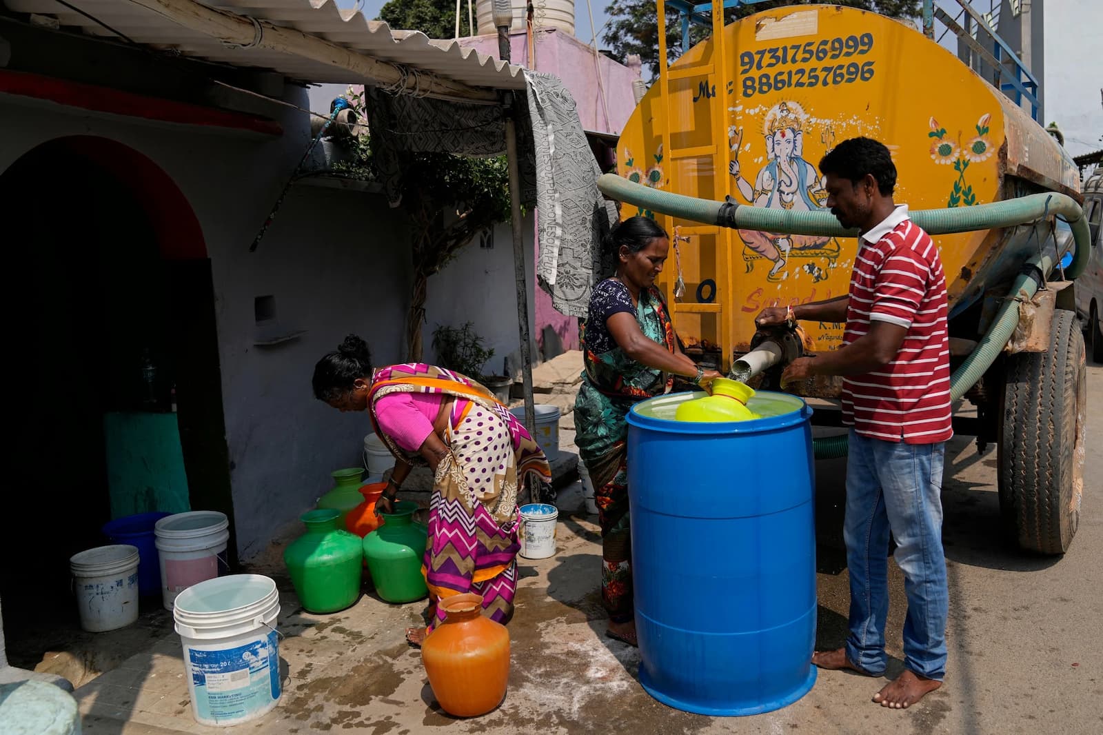 Residents collect potable water from a private tanker in Ambedkar Nagar, a low-income settlement in east Bengaluru (Image: Aijaz Rahi / Associated Press / Alamy)