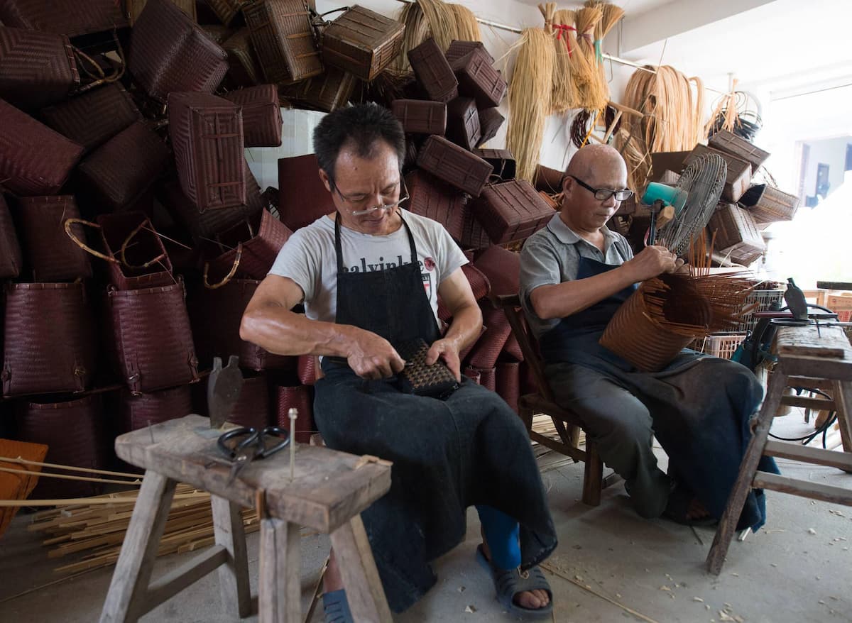 Two craftsmen make traditional bamboo products at a workshop in the county of Anji, eastern China (Image: Weng Xinyang / Imago / Alamy)